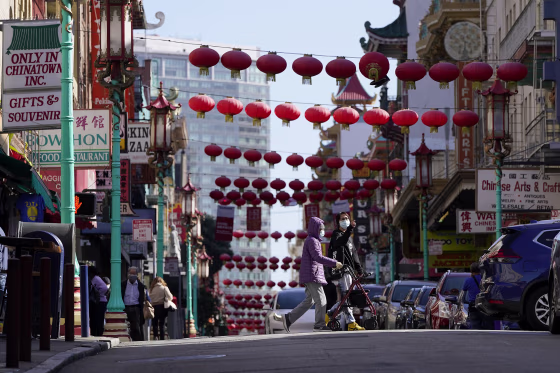 People cross Grant Avenue in Chinatown in San Francisco on March 25. 
