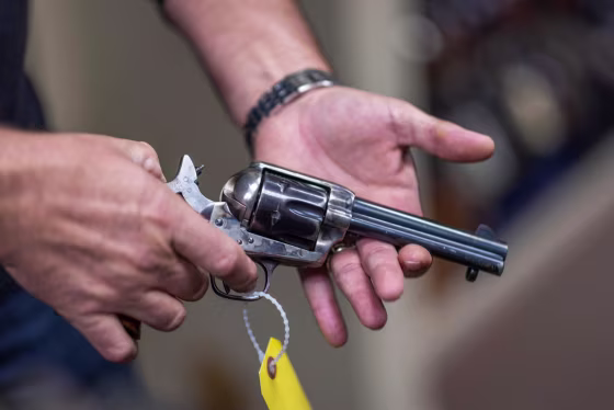 Props expert Guillaume Delouche at Independent Studio Services holds a prop gun in Los Angeles on Oct. 22, 2021.