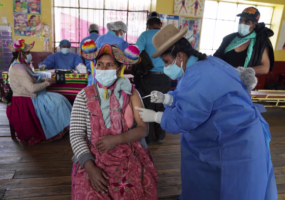 Image: A healthcare worker gives a shot of a Covid-19 vaccine to Yolanda Coila, in Jochi San Francisco, Peru, on Oct. 29, 2021.