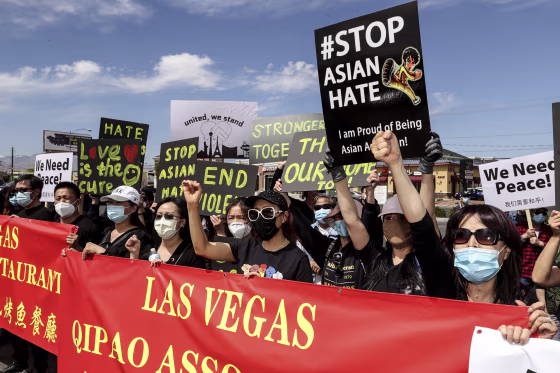 People, including Jenny Li of Las Vegas, right, rally at a "Stop Asian Hate" event at Chinatown Plaza Las Vegas on April 1, 2021.