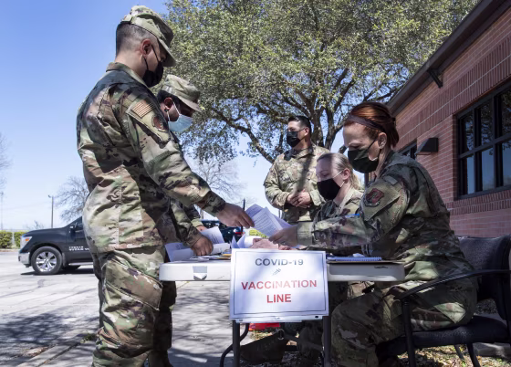 Members of the 149th Fighter Wing check in for their appointments to get Covid-19 vaccine shots at Joint Base San Antonio-Lackland, Texas, on March 18.