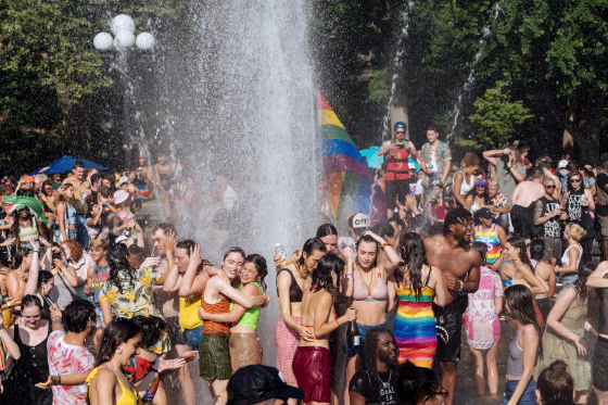 Young people cool off in the fountain at Washington Square Park in New York City on June 27, 2021, during the Pride March.