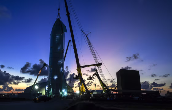 Image: Workers put the finishing touches on a prototype of a spaceship called Starship before SpaceX CEO Elon Musk arrives to update the progress on the project on Sept. 27, 2019.