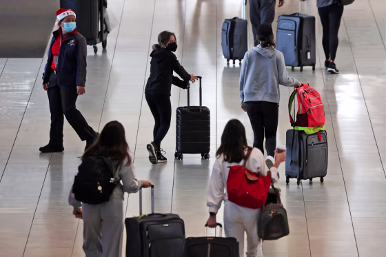 Passengers walk through a terminal at Baltimore/Washington International Thurgood Marshall Airport on Dec. 22, 2021 in Baltimore, Md.
