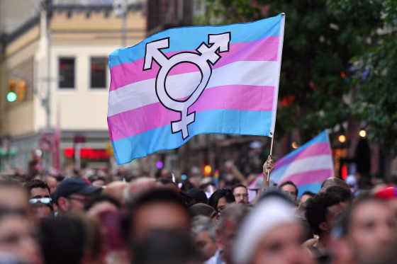 A transgender pride flag is waved outside the Stonewall Inn in New York in 2019.