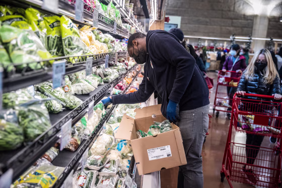 An employee restocks shelves at the Trader Joe's Upper East Side Bridgemarket grocery store in New York on Dec. 2, 2021.