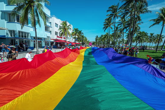 People carry a rainbow flag during the Miami Beach Pride Festival in South Beach, Fla., on Sept. 19, 2021.