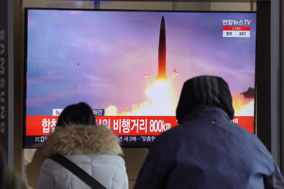 People watch a TV showing a file image of North Korea's missile launch during a news program at the Seoul Railway Station in Seoul, South Korea, Sunday, Jan. 30, 2022.