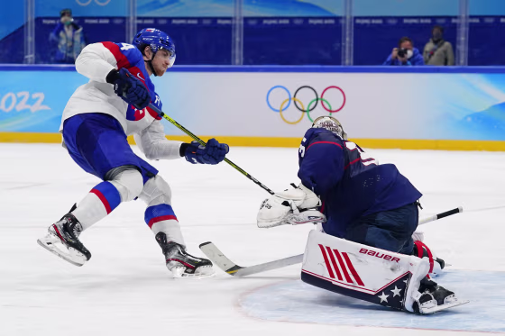 Slovakia's Peter Cehlarik, left, scores the winning goal past United States goalkeeper Strauss Mann (31) during a shoot-out in a men's quarterfinal hockey game at the 2022 Winter Olympics, Wednesday, Feb. 16, 2022, in Beijing. Slovakia won 3-2.