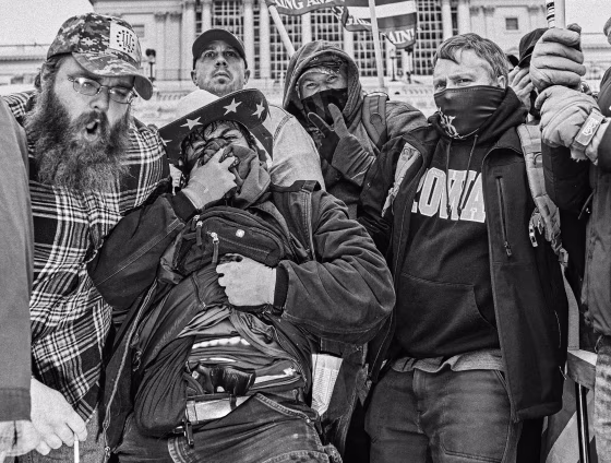 John Emanuel Banuelos flashes a gun strapped in his waistband as supporters of Donald Trump gathered outside the Capitol building on Jan. 6, 2021.