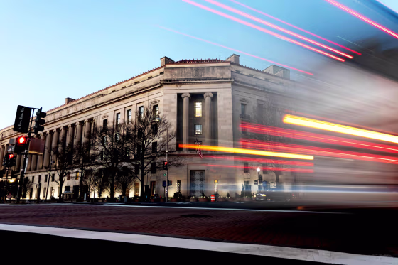 A vehicle drives past the Department of Justice building in Washington on Feb. 9, 2022.