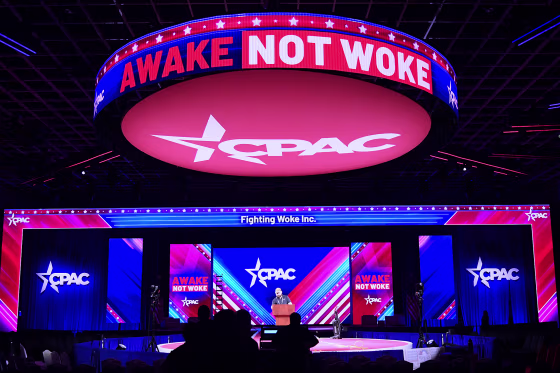 Workers prepare the stage for the 2022 meeting of the