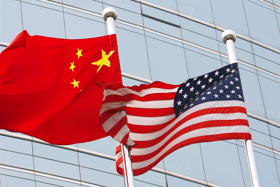A US and a Chinese flag wave out