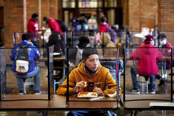 Students eat lunch at Wyandotte County High School in Kansas City, Kan., on March 31, 2021.