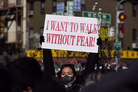 People hold signs during a rally in response to the killing of Christina Yuna Lee in New York's Chinatown neighborhood on Feb. 14, 2022.