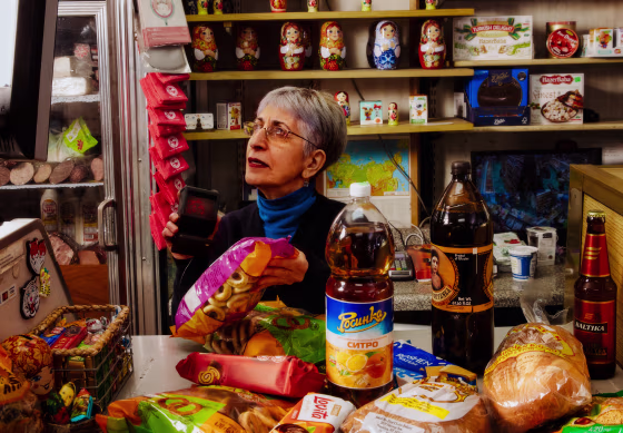 image: Marina Begiv scans products for sale at her store, Moscow on Hudson, in New York on March 9.