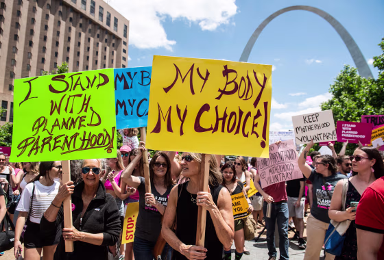 Abortion rights supporters hold signs as they rally near the Gateway Arch in St. Louis, Mo., on May 30, 2019.