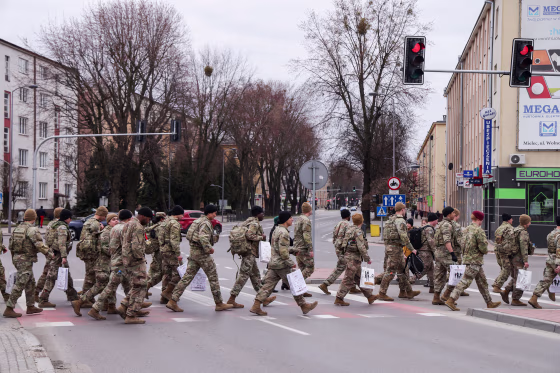Soldiers from the U.S. Army's 82nd Airborne Division depart after many of them participated in a commemorative run with locals in the town center on March 6, 2022, near Mielec, Poland.
