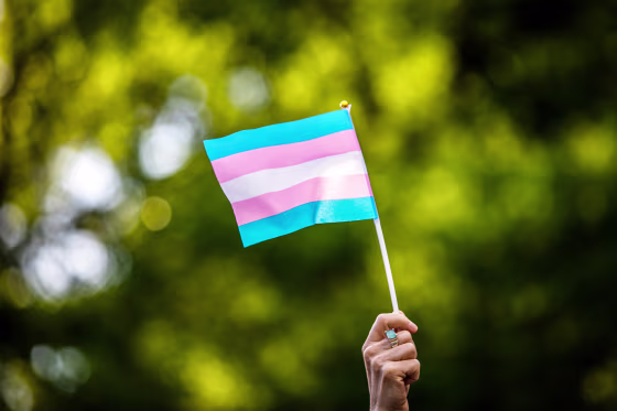Transgender rights activist waves a transgender flag as they protest the killings of transgender women this year, at a rally in Washington Square Park in New York on May 24, 2019.