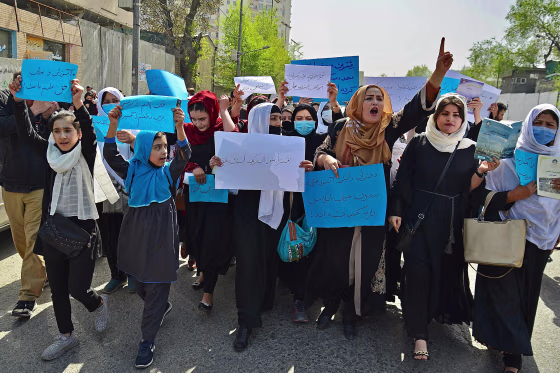 Image: Afghan women and girls take part in a protest in front of the Ministry of Education in Kabul on March 26, 2022, demanding that high schools be reopened for girls.