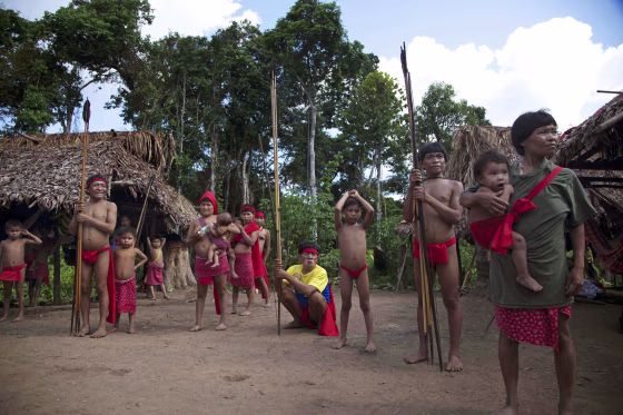 Yanomami Indians stand at their village called Irotatheri in Venezuela's Amazon region, on Sept. 7, 2012.