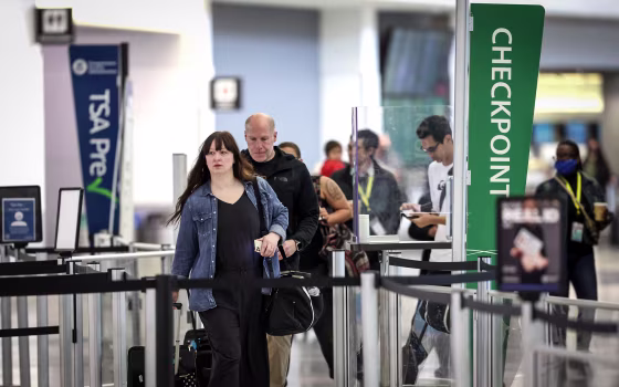 Image: Airline passengers without face masks prepare to enter a security checkpoint at San Francisco International Airport on April 19, 2022 in San Francisco.