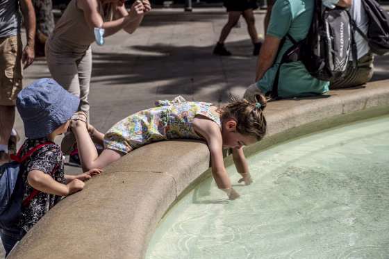A kid cools off in the public fountain in Plaça Reial, Barcelona on Aug. 12, 2021.