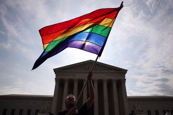 Image: A supporter of gay marriage waves a flag in front of the Supreme Court Building June 25, 2015.