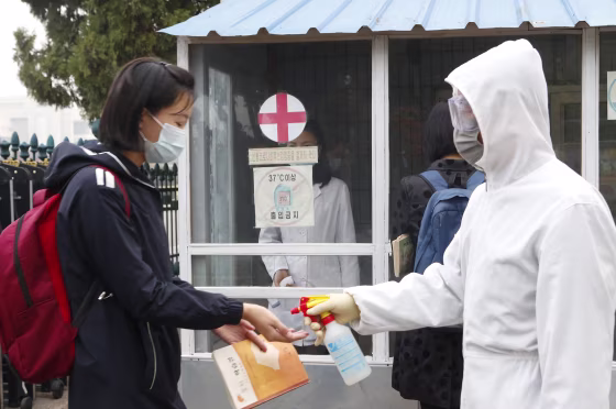 A student’s hands are disinfected at a school in Pyongyang, North Korea, last year.