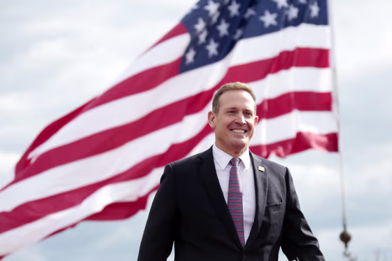 Republican senate candidate Ted Budd smiles as he takes the stage before former President Donald Trump speaks on April 9, 2022, in Selma, N.C.
