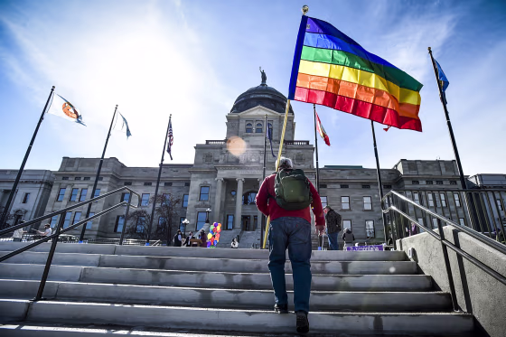 Demonstrators gather on the step of the Montana State Capitol protesting anti-LGBTQ+ legislation on March 15, 2021, in Helena, Mont.