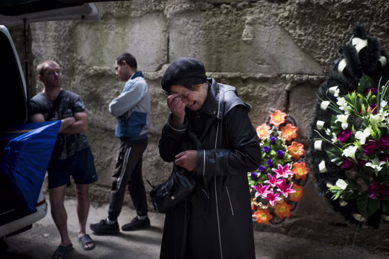 Olga Kotenko cries while waiting for the remains of her son, Volodymyr, outside a morgue in Kharkiv. 