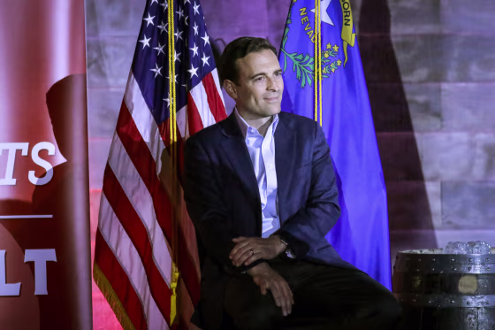 Republican Senate candidate from Nevada Adam Laxalt sits near Florida Governor Ron DeSantis who speaks at a campaign event for Lexalt at Stoneys Rockin Country on April 27, 2022 in Las Vegas.