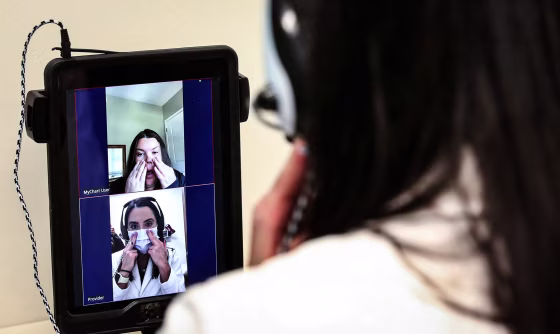 Dr. Lisa Ravindra conducts a remote monitoring telehealth visit with patient Jenny Thomas, top of screen, at Rush River North in Chicago, on Oct. 5, 2020.