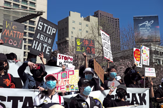 People take part in a rally against racism and violence on Asian Americans