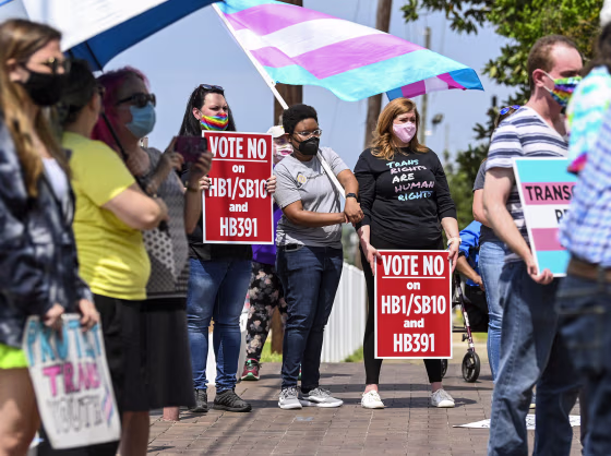 Opponents of several bills targeting transgender youth attend a rally at the Alabama State House in Montgomery, on March 30, 2021.