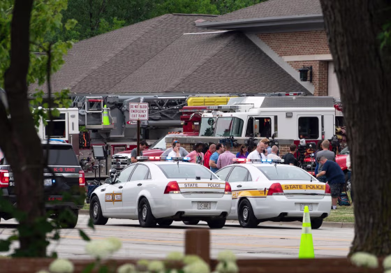 Law enforcement officers gather at the scene of the Fourth of July parade shooting in Highland Park, Ill.