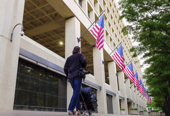 A person walks in front of the FBI headquarters