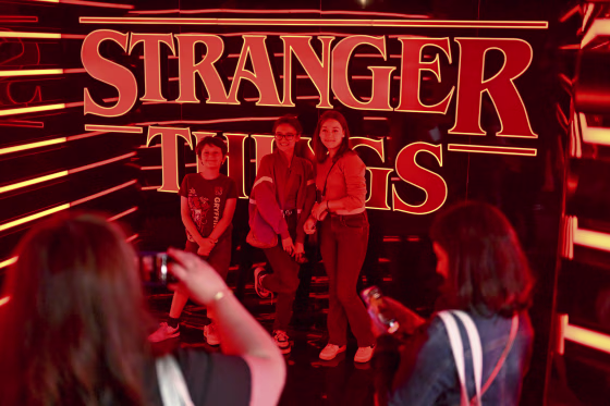 People take photos at the pop-up Stranger Things store in Paris, on June 25, 2022.
