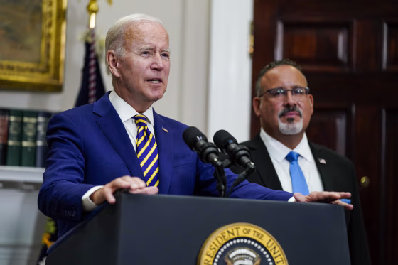 Image: President Joe Biden and Education Secretary Miguel Cardona address the press about student loan debt forgiveness in the White House, on August 24, 2022, in Washington.