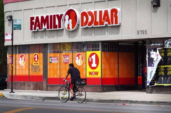 A cyclist rides past a Family Dollar store