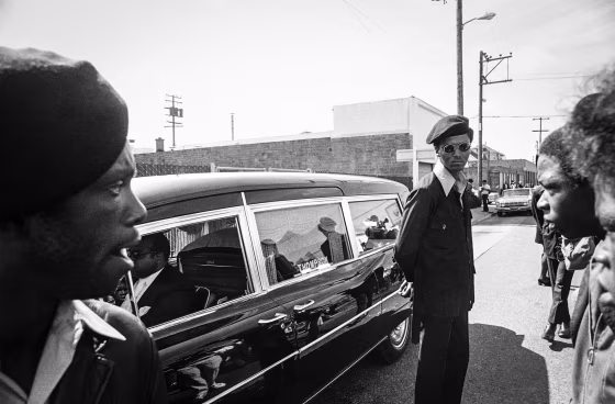 Black Panthers stand guard on Aug. 28, 1971, in Oakland, Calif., while the hearse carrying the body of George Jackson was brought to St. Augustine's Episcopal Church.