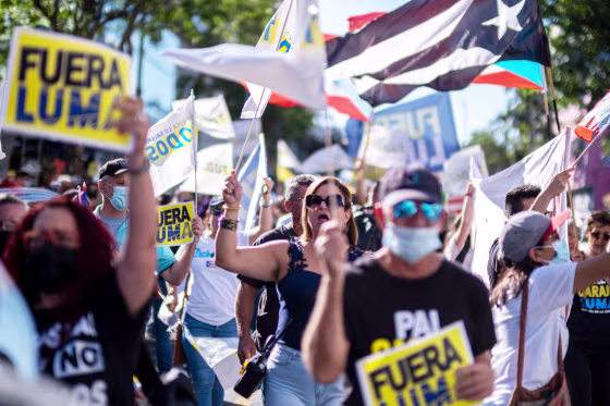 People protest outside the headquarters of Luma Energy