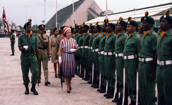 Image: Queen Elizabeth ll inspects an honor guard as she arrives in Barbados on Oct. 31, 1977.
