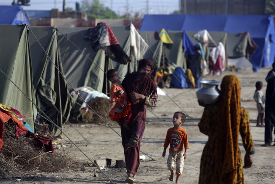 Victims of heavy flooding from monsoon rains take refuge at a temporary tent housing camp organized by the UN Refugee Agency in Sukkur, Pakistan, Saturday, Sept. 10, 2022.