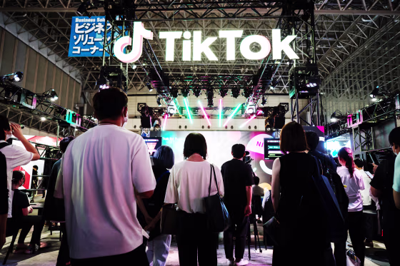 Attendees stand outside the TikTok booth