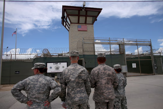 Military officers stand at the entrance at the Guantanamo Bay Facility