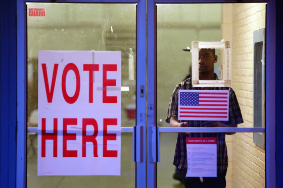 A voter exits a polling station during the presidential primary in Camden, Alabama