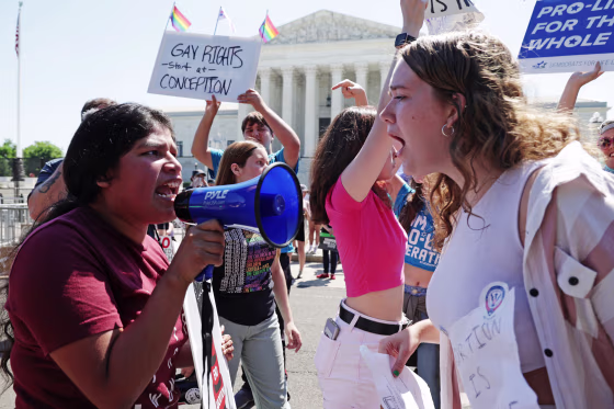 An abortion-rights activist argues with an anti-abortion activist in front of the Supreme Court on June 25, 2022.