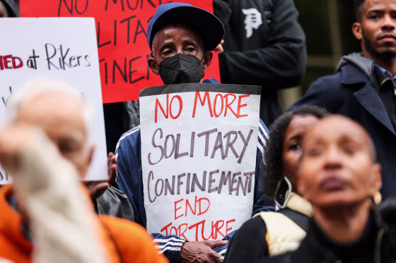 People protest outside City Hall over conditions on Rikers Island on Oct. 25, 2022, in New York.